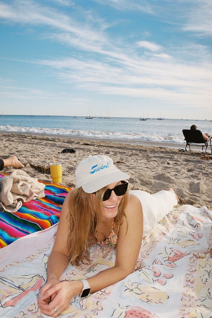 The "Swim" hat is 100% garment-washed cotton twill with an unstructured fit and slightly curved visor. Embroidered in Santa Barbara. One size fits most Unisex Off-white cream color Embroidered logo on front & back Adjustable metal closure 100% garment-washed cotton twill Summer Beach Sun Hat With Curved Bill, Curved Bill Sun Hat For Summer Beach, Spring Beach Sun Hat With Curved Bill, Summer Beach Dad Hat With Curved Visor, Summer Beach Baseball Cap With Curved Bill, Cotton Beach Baseball Cap, Cotton Baseball Cap For Beach, Curved Bill Baseball Cap For Beach In Summer, Adjustable Cotton Dad Hat For Beach