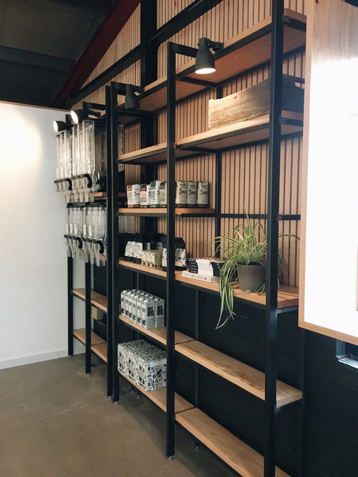 the shelves are filled with plants and boxes