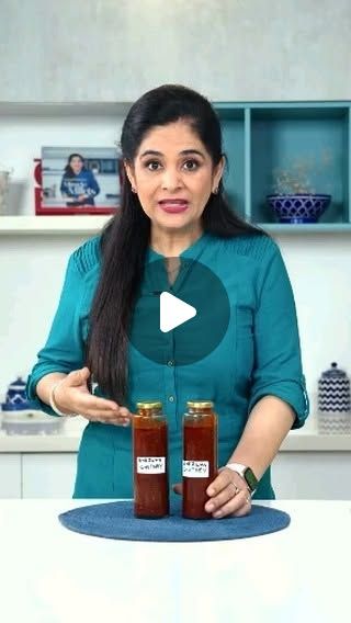 a woman holding two jars of food in her hands