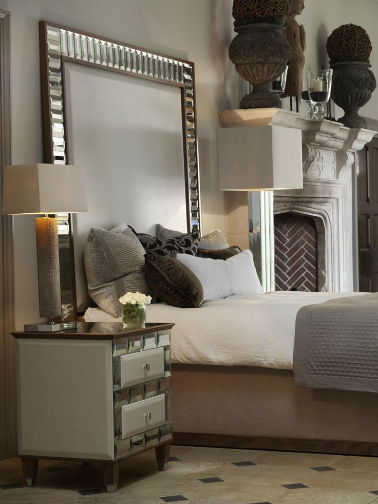 a bedroom with a bed, dresser and mirror on the wall next to each other