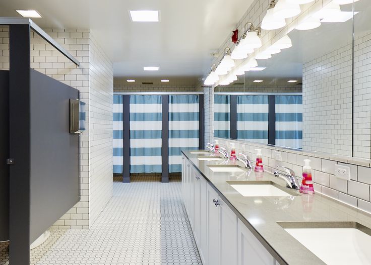 a public restroom with sinks and mirrors