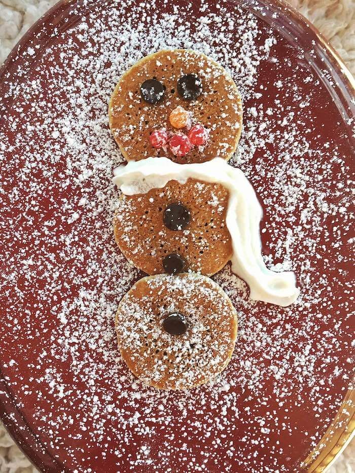 a plate topped with donuts covered in powdered sugar and frosting on top of it