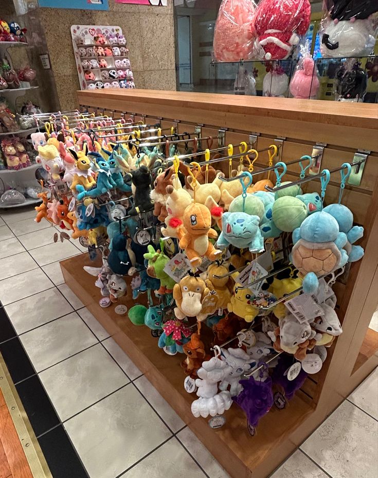 a bunch of stuffed animals are on display in a toy store with other plush toys