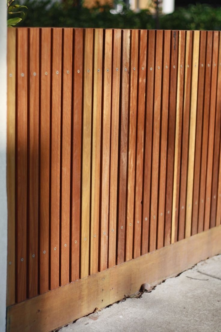 a wooden fence that is next to a building