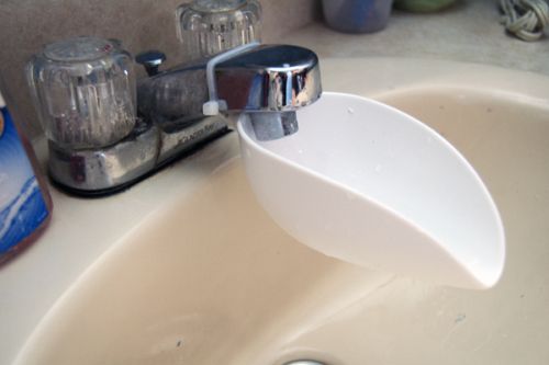 a close up of a sink with soap dispenser