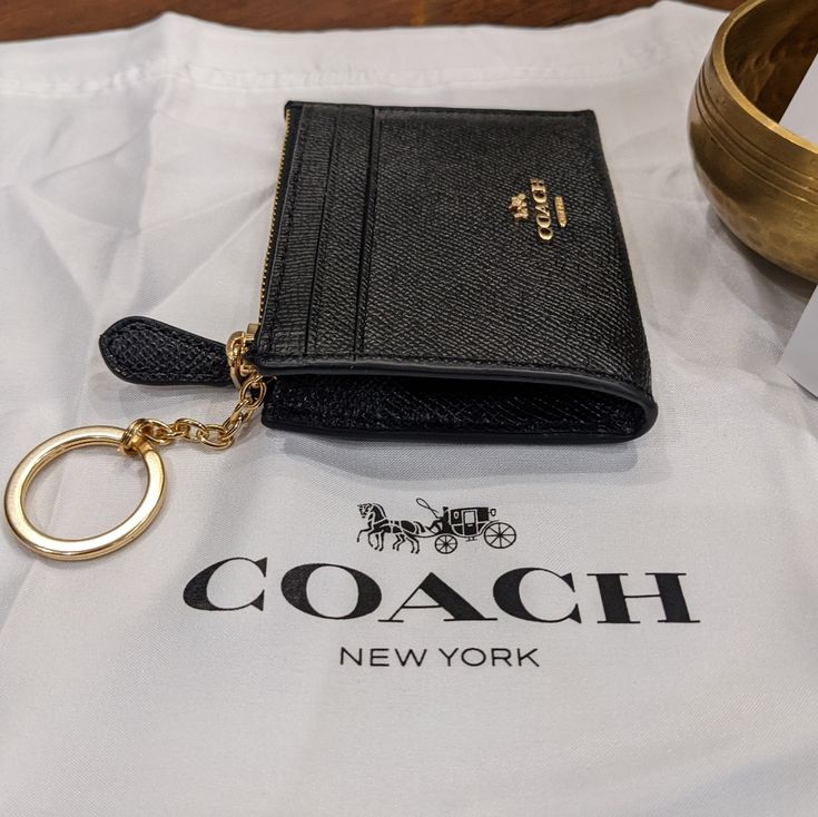 Item: Id / Card Case + Gift Box (Dust Bag Not Included) Brand: Coach / Skinny Mini Id Condition: New With Tags Ticketed Price: $75.00 Size: 4 1/4" (L) X 3" (H) X 1/2" (W) Color: Black - Gold Hardware Details: Crossgrain Leather Two Credit Card Slots Id Window Zip-Top Closure, Fabric Lining Attached Split Key Ring 4 1/4" (L) X 3" (H) X 1/2" (W) Style No. F88250 I Hope You Love It Too... Classic Coach Wallet As Gift, Classic Black Coin Purse As Gift, Classic Coach Coin Purse As Gift, Classic Rfid Blocking Coin Purse Gift, Coach Elegant Wallets Perfect For Gifts, Elegant Coach Wallet As Gift, Elegant Coach Wallets As Gift, Coach Bags With Card Slots For Gift, Luxury Coach Wallets As Gift