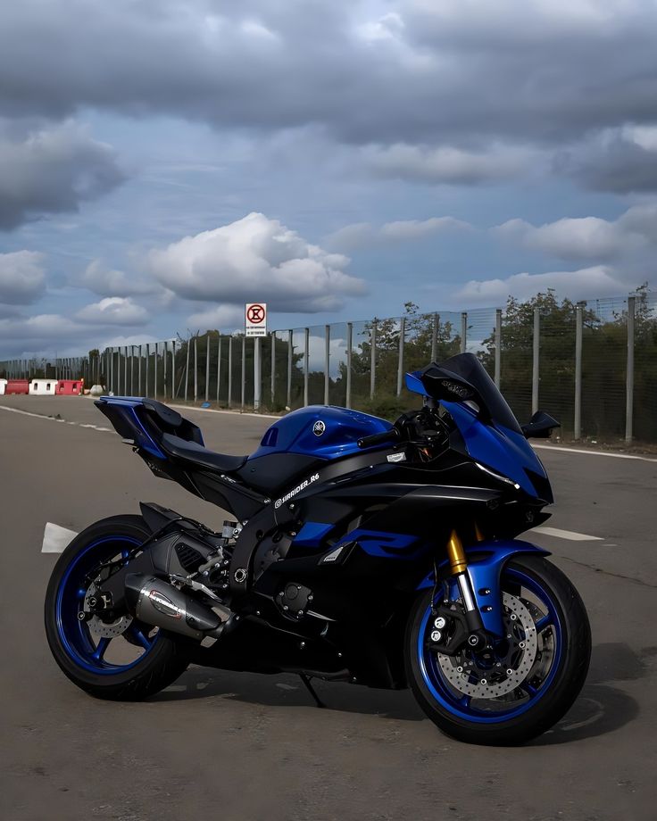 a blue motorcycle is parked on the side of the road