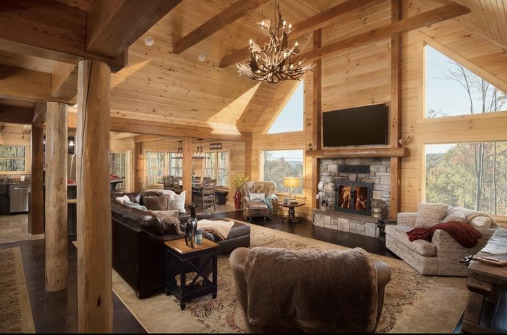 a living room filled with lots of furniture and a chandelier hanging from the ceiling