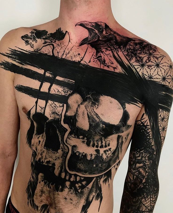 a man's back with a skull tattoo on it