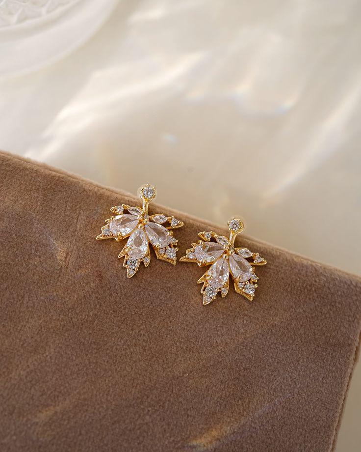 Discover a new level of elegance with our Ella Ear Jackets! Made with sparkling cubic zirconia and designed in the shape of delicate leaves, these earrings will enhance your natural beauty and elevate any outfit. Treat yourself or someone special to these stunning little luxuries! EARRINGS FEATURE Material: Brass, White Cubic Zirconia Finish: 16K gold plating Elegant Leaf-shaped Earrings, Elegant Leaf-shaped Earrings For Formal Occasions, Elegant Leaf-shaped Formal Earrings, Elegant White Leaf-shaped Earrings, Ear Jacket, Freshwater Pearls Earrings, Someone Special, Pretty Earrings, Moonstone Ring