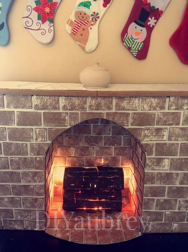 a brick fireplace with stockings hanging on the wall and an open fire place in front of it