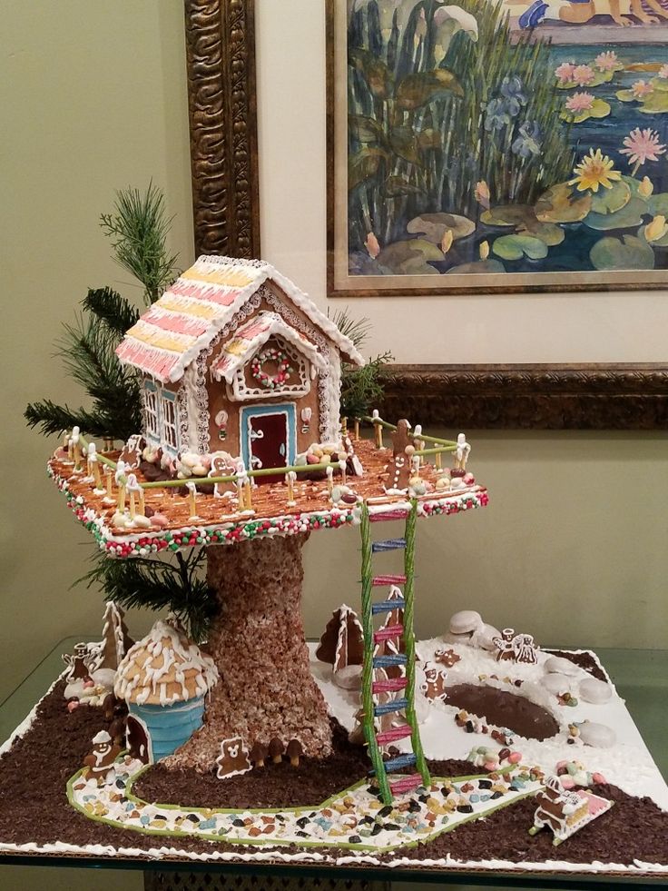 a gingerbread house is displayed on a table