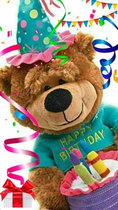 a brown teddy bear wearing a birthday hat and holding a cake with candles in it