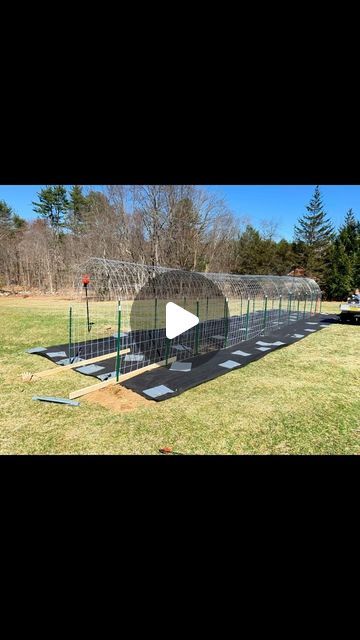 an outdoor batting cage in the middle of a field