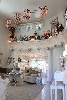 a living room filled with furniture and christmas decorations