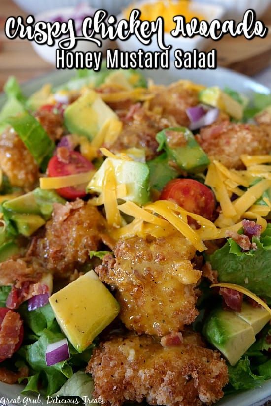 a close up of a plate of food with meat and vegetables on it that says crispy chicken salad