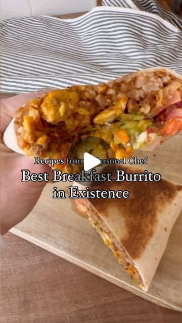 a person holding a burrito in their hand with the words, best breakfast burrito in