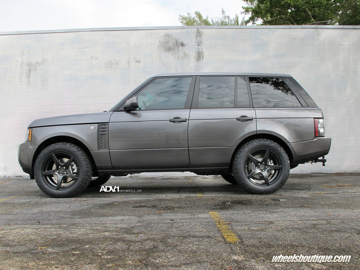 an suv parked in front of a white wall