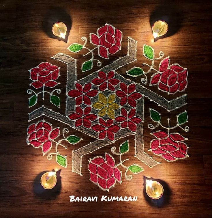 an intricately decorated diya with candles on the floor