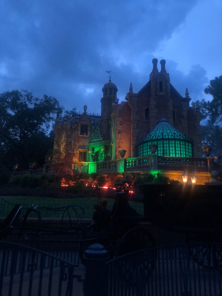 a large building lit up with green lights