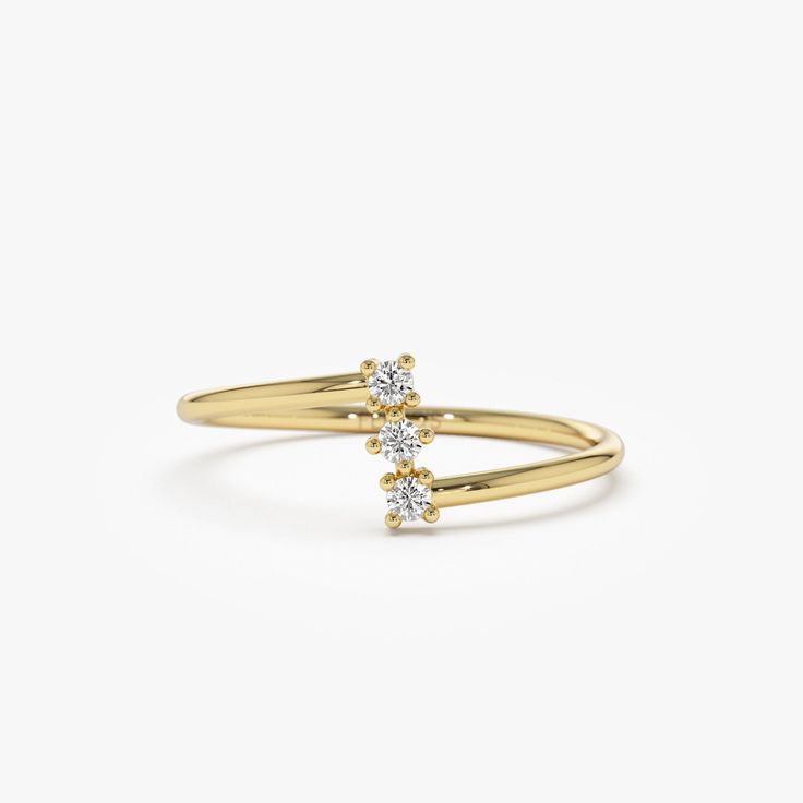 a yellow gold ring with two diamonds on the top and bottom, set against a white background