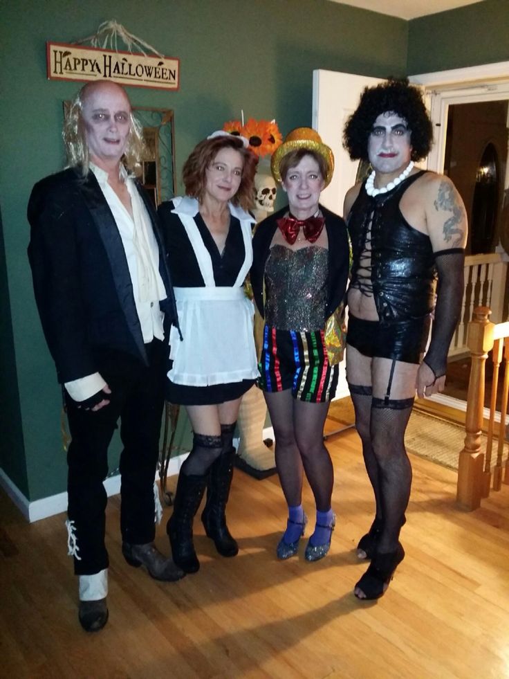 four people dressed up in costumes posing for a photo