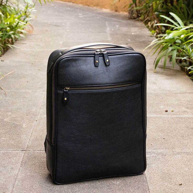 A Leather Backpack designed to carry your 15 inch Laptop and A4 Documents. Features a Top Handle to carry with ease making this the Ideal Work Buddy. Handmade from Black Full Grain Leather.  Leather is soft in touch and feel, and is Pebble Grained making it resistant to everyday wear and tear.  Interior of the Backpack is crafted from Viscose Fabric that is soft.  YKK Zippers ensures smooth functioning and a long lasting product Adjustable Straps with Buckles, which are made from certified Brass Classic Black Laptop Backpack, Daily Use Laptop Backpack With Luggage Sleeve, Black Leather Rectangular Backpack With Laptop Sleeve, Black Laptop Bag Backpack With Luggage Sleeve, Black Standard Backpack Laptop Bag For Daily Use, Black Rectangular Backpack With Luggage Sleeve, Black Leather Travel Backpack With Laptop Sleeve, Versatile Black Backpack With Laptop Sleeve, Black Leather Backpack With Laptop Sleeve For Travel