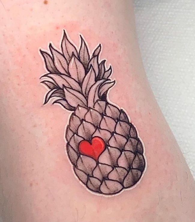 a pineapple tattoo with a heart on it