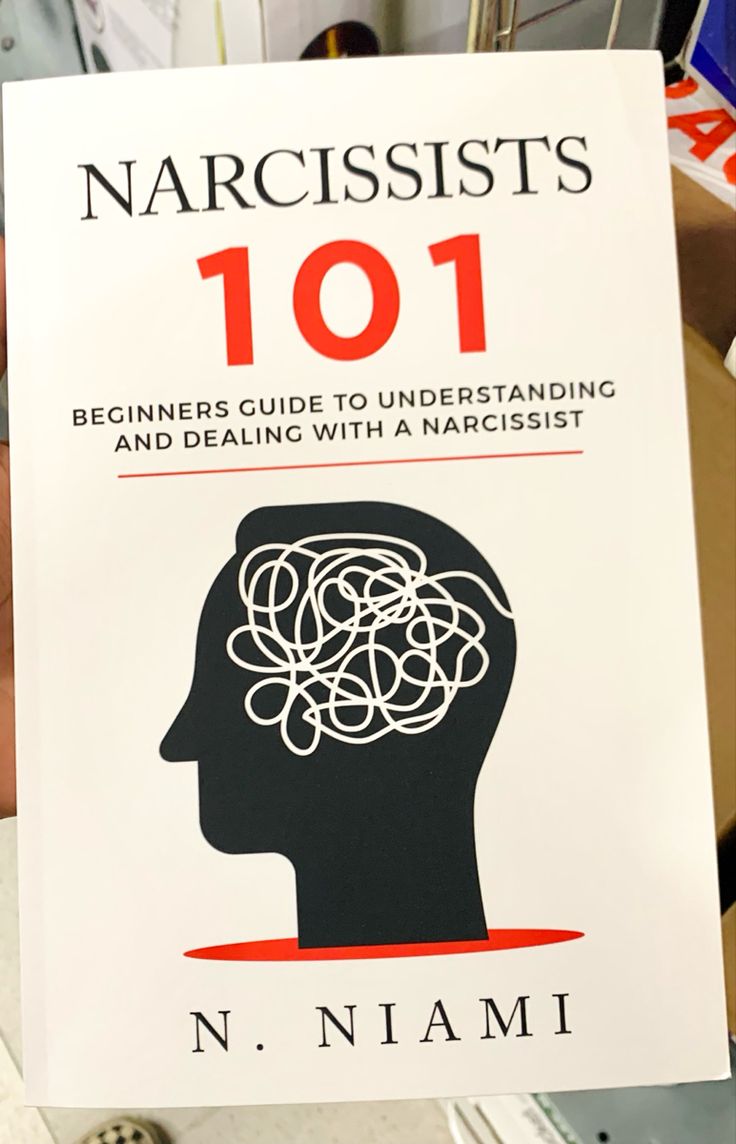 the book narcissists 101 is being held up by someone's hand