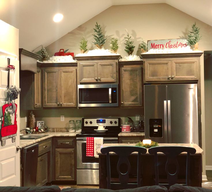 a kitchen decorated for christmas with holiday decorations