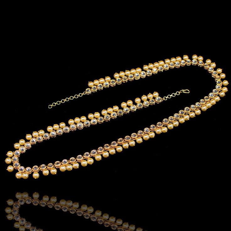 Add some fun and flair to your festive look with a little help from Mayah waist chain! Classic waist chain studded with kundan stones and dangling pearl beads. Approximately 30" or 72cm in length. Gold-plated on high-quality brass as base metal. In-stock & ready-to-ship. *Please Note: We use faux stones and beads in all of our jewelry. Festive Look, Waist Chain, Faux Stone, Base Metal, Pearl Beads, Some Fun, Pearl Necklace, Gold Plate, Plating