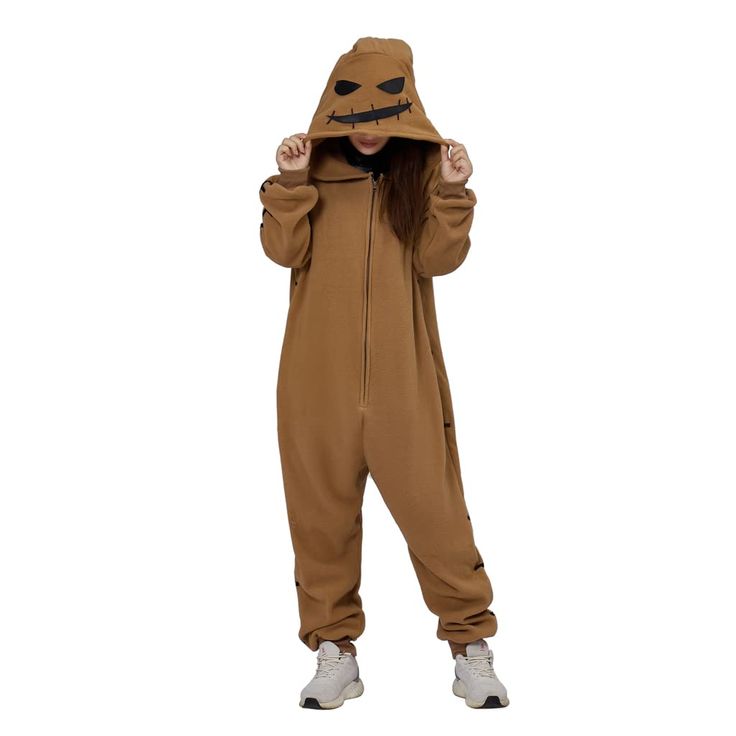 a person wearing a brown costume with a mask on their head and hands in the air