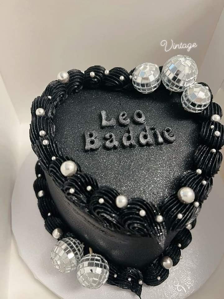 a heart shaped cake with the words le badne written on it in black frosting