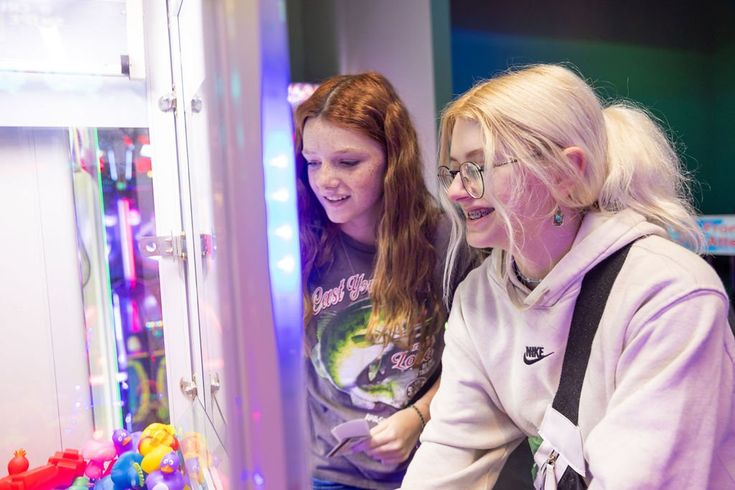 two women looking at something in a display case