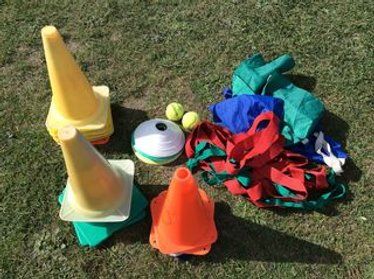 an assortment of plastic toys on the ground with balls and other items to play with