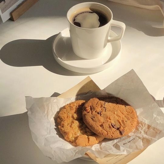 two cookies and a cup of coffee on a table