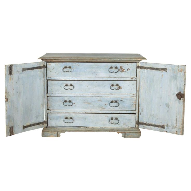 an old blue dresser with two doors open on the front and one door closed to reveal a drawer