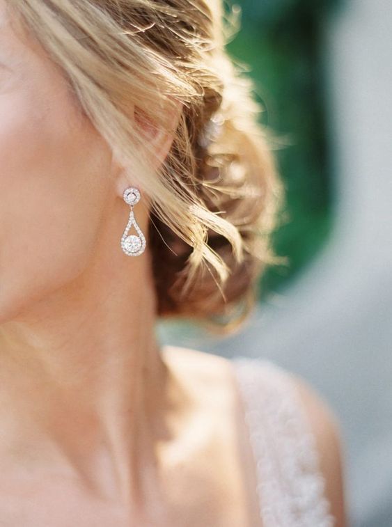 a close up of a woman wearing earrings