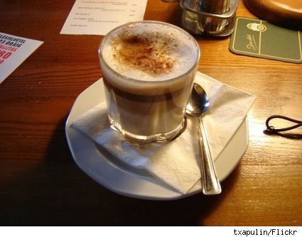 a cappuccino is sitting on a white plate