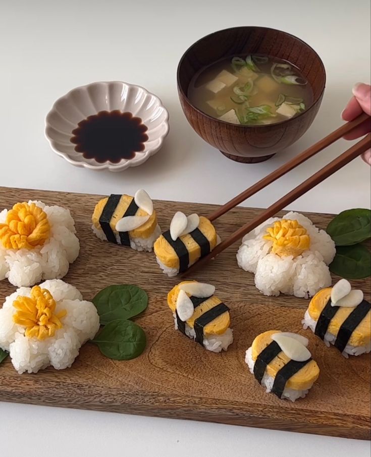 sushi on a wooden board with chopsticks next to it