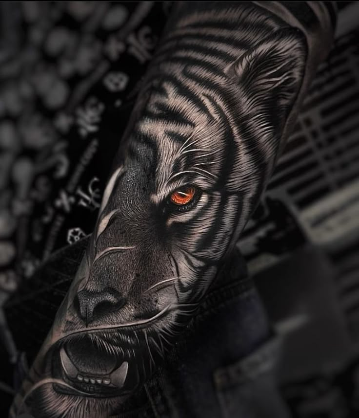 a black and white tiger with orange eyes on his arm, done by the artist