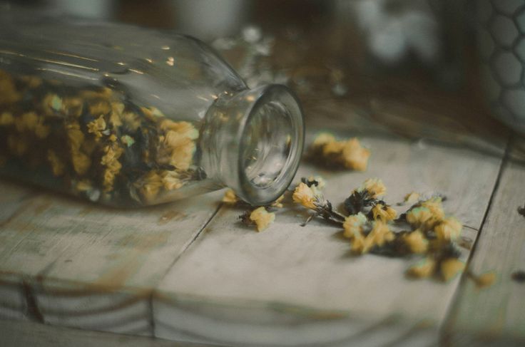 a glass jar filled with food sitting on top of a wooden table