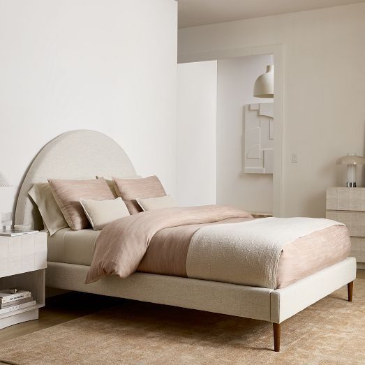 a bedroom with a bed, nightstands and other items in the room that are all white