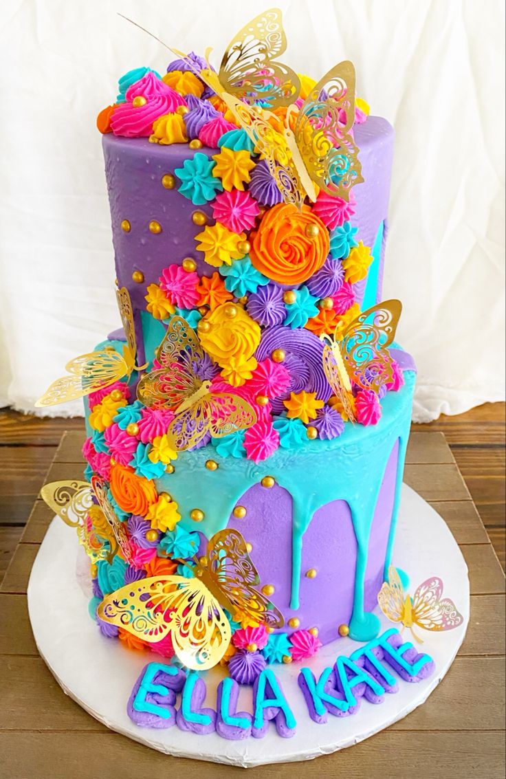 a colorful birthday cake decorated with flowers and butterflies