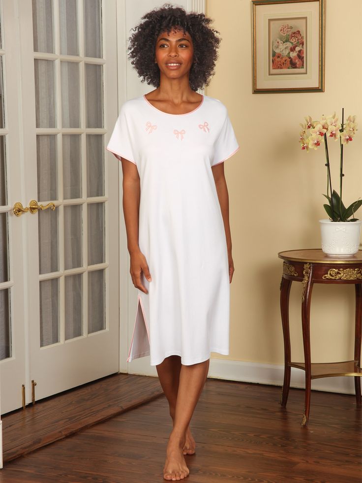 This adorable nightgown is specifically designed to be loose fitting and carefree, so you feel totally at home whenever you’re in it. The casual style allows you to move freely, without tightness or other restrictions. And thanks to a forgiving cut and generous drape, fabric won’t linger keeping things airy and breathable. Plus, you can showcase your silhouette in a way that makes you comfortable. Speaking of comfort, your skin will sing at the touch of our silky-smooth 100% pima cot Comfortable Spring Nightgown For Sleep, Spring Loungewear Nightgown Relaxed Fit, Comfortable Cotton Nightgown For Lounging, Relaxed Fit Short Sleeve Dress For Loungewear, Relaxed Fit Short Sleeve Loungewear Dress, White Feminine Sleepwear For Relaxation, White Cotton Nightgown For Lounging, Cotton Relaxed Fit Nightgown For Relaxation, Comfortable Relaxed Fit Nightgown For Bedtime