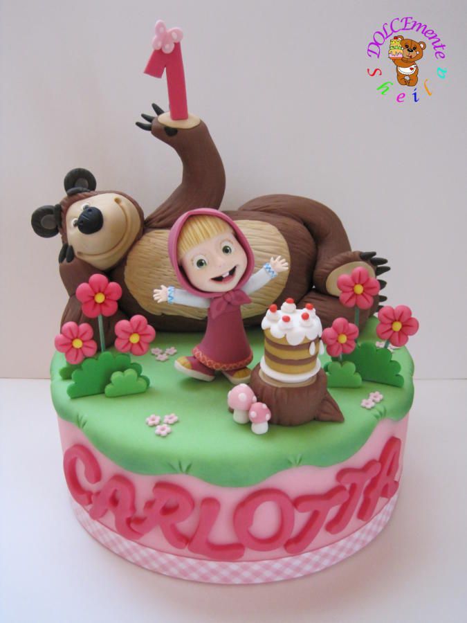 a birthday cake decorated with an animal and girl