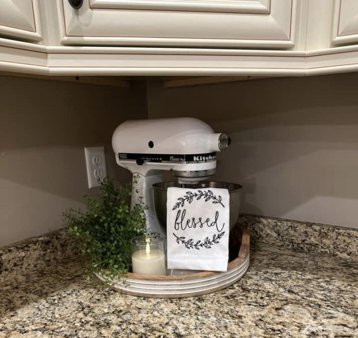 a white mixer sitting on top of a kitchen counter next to a sign that says class