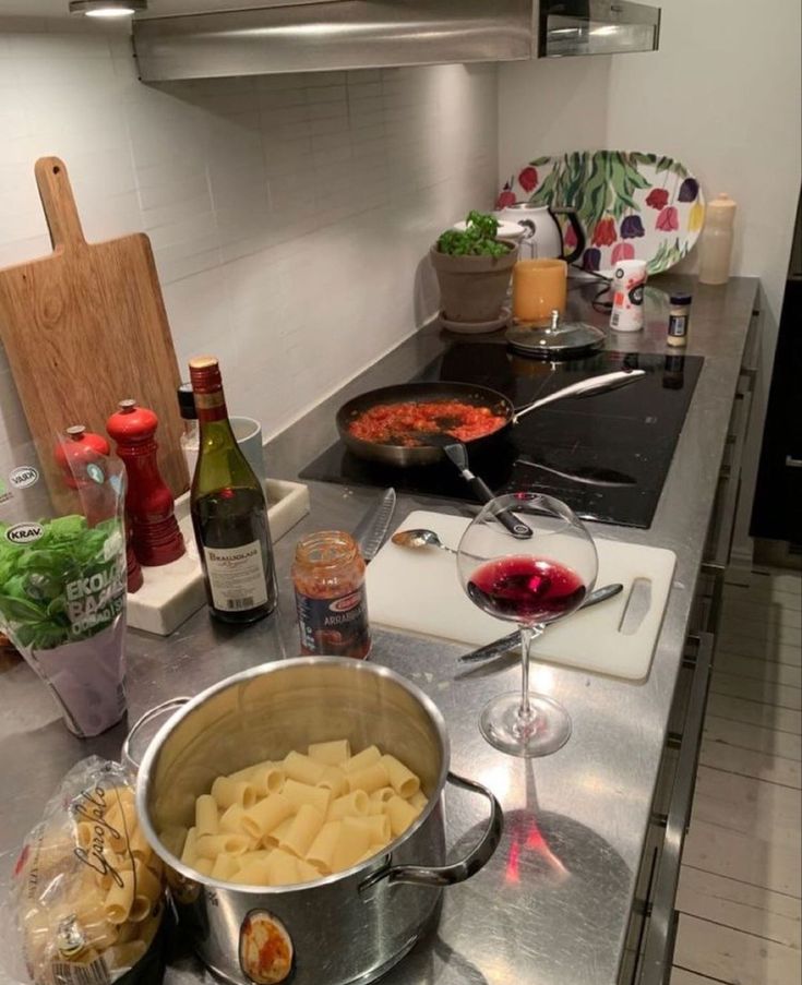 a kitchen counter topped with lots of food and wine