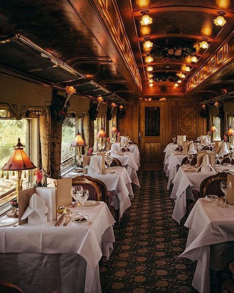 a dining car on a train with white tablecloths