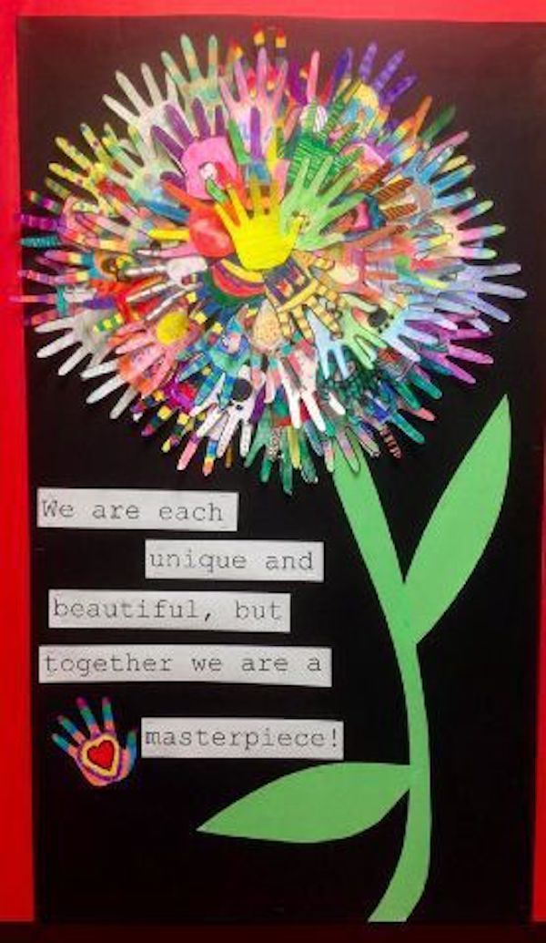 a flower made out of handprints on a bulletin board with the words, we are